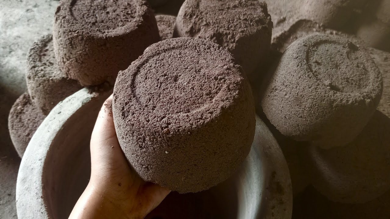 soft dusty and crunchy old red sand with charcoal chips dry clay pot and water steel pot crumbling 