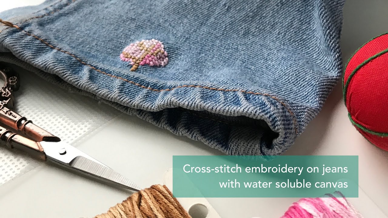 Cross stitch embroidery on jeans with water soluble canvas