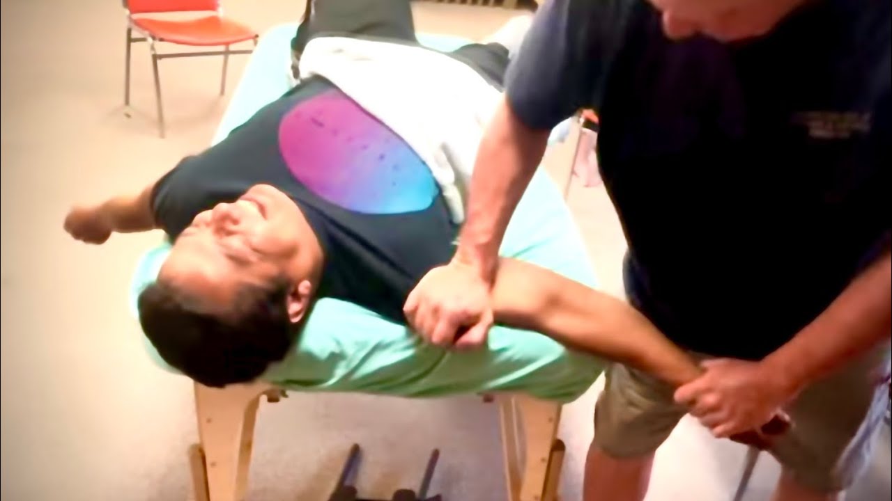 Intense deep shoulder massage. Raynor massage of arm and shoulder.