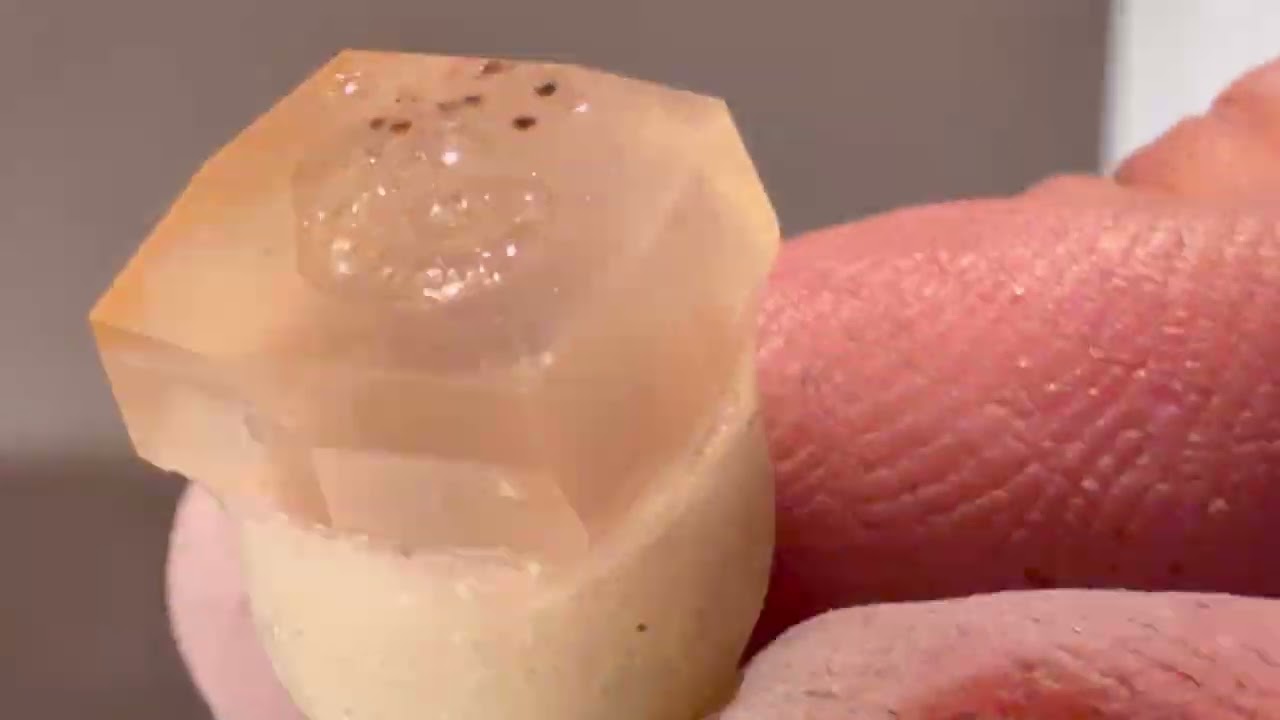 A tiny little white/orange Chalcedony Agate - homemade faceting machine