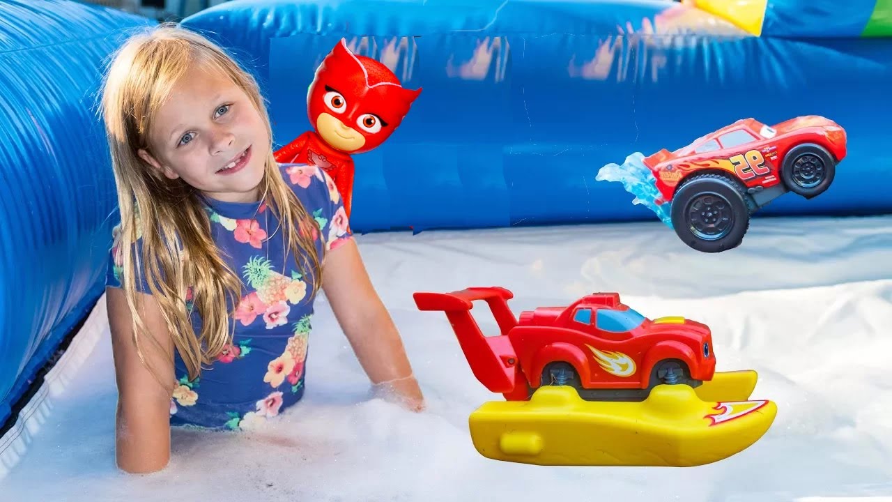 Assistant Plays with Paw Patrol in a Bounce House Slip n Slide
