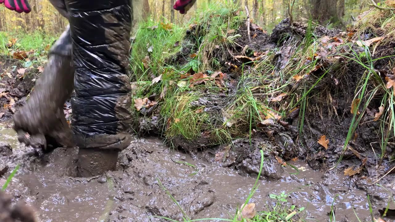 Trying my new shiny snowsuit and my pink boots  in the mud for the first time