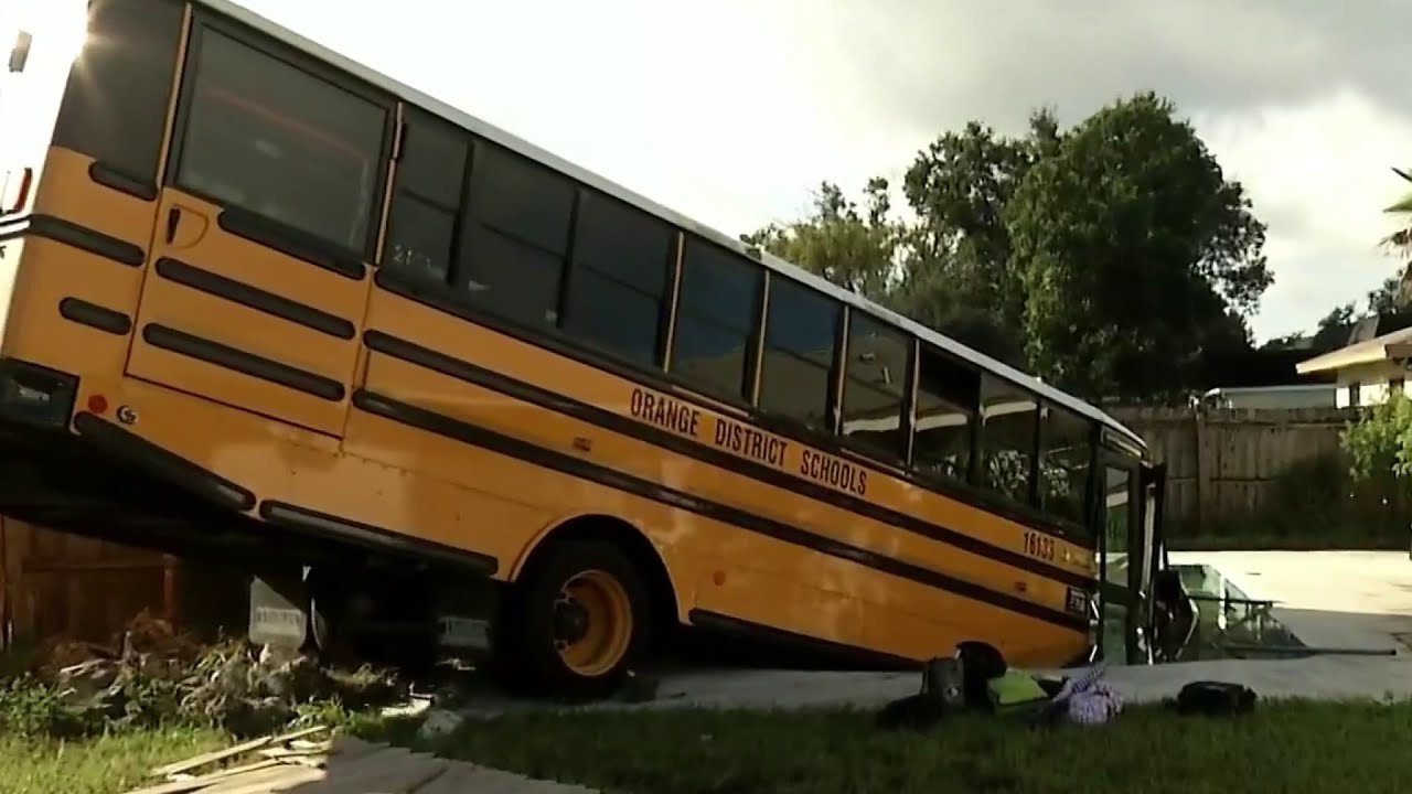 School bus crashes into swimming pool