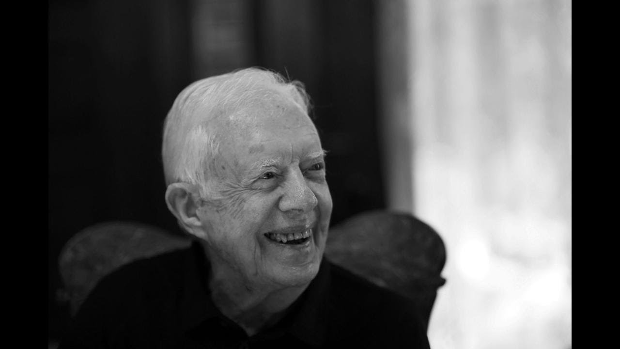 Jimmy Carter’s casket processes through Plains to Atlanta