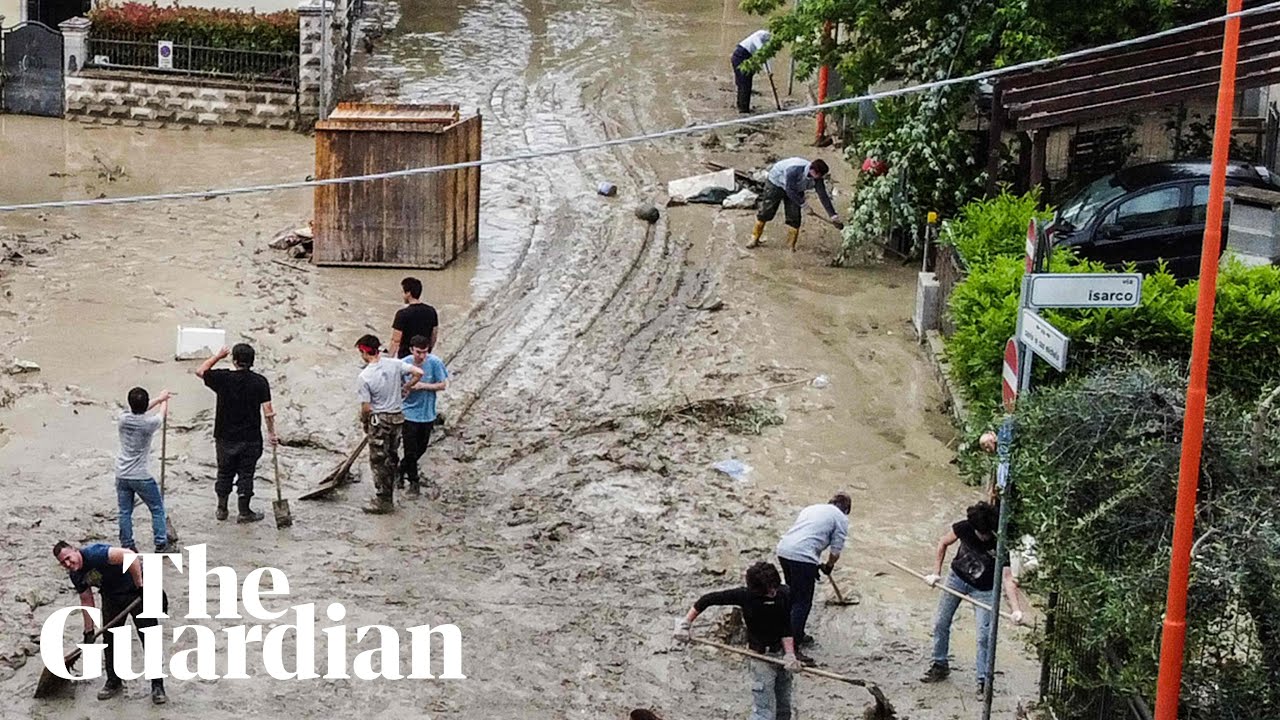 Drone footage shows residents clearing up mud in flood-hit Italy