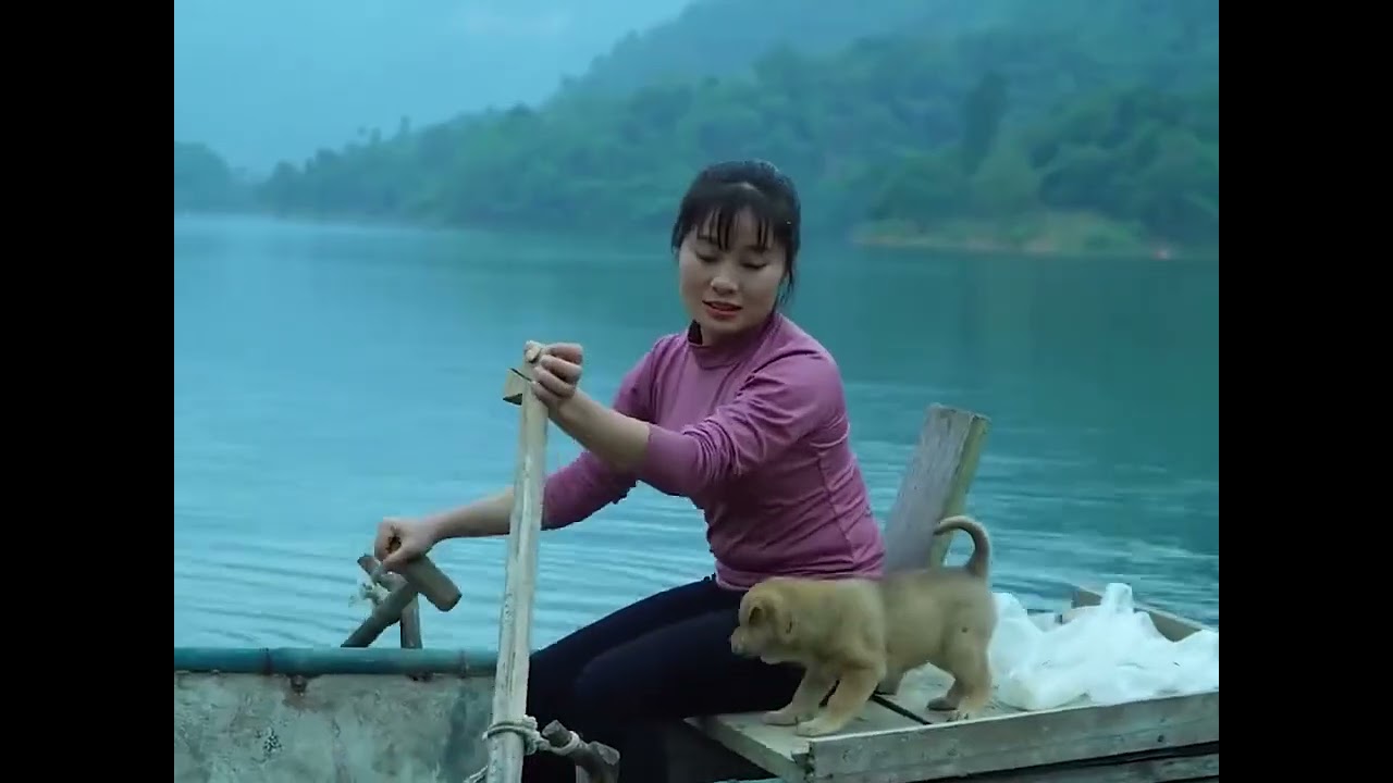 Fishing on a calm lake in a small wooden boat&hellip;Surrounded by blue water, green  vibe of rural life.