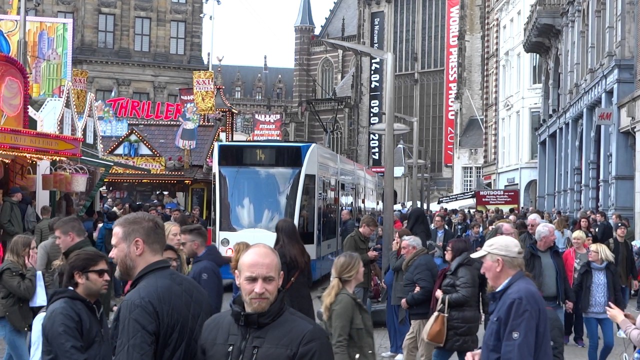 Paasdrukte Amsterdam: Tramlijn 14 baant zich een weg langs de kermis op de Dam