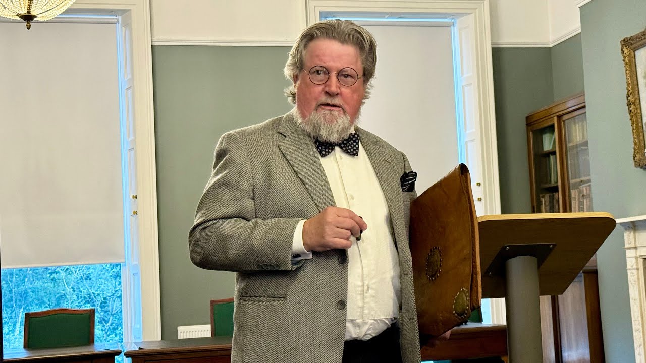 Denis Conway portrays AE