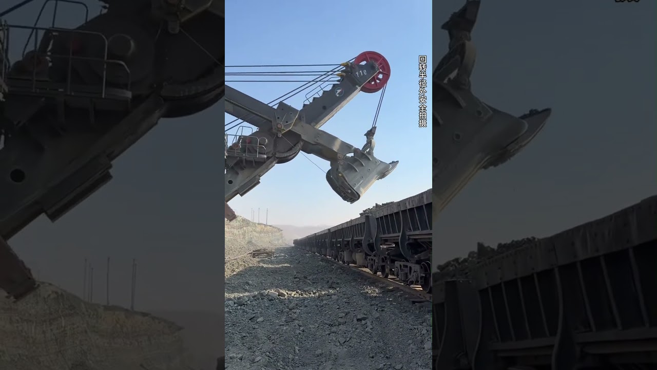 Large excavators are mining ore and loading it onto trains. 02072026