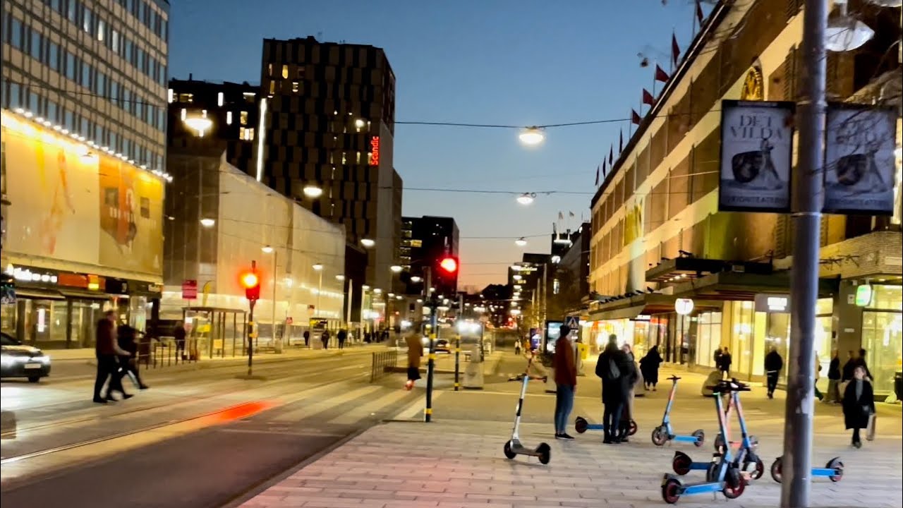 Stockholm Walks: Klarabergsgatan. City center and its lights and people. Yellow & blue for Ukraine
