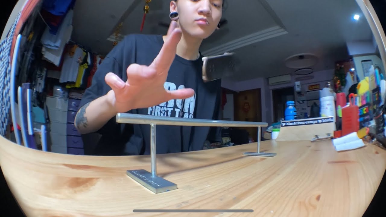 TRE FLIP TRICK TIP ON A FINGERBOARD