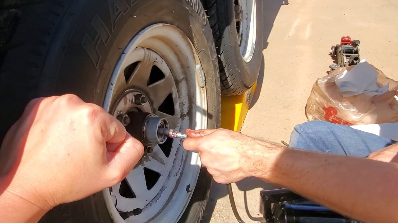 Jack up a double-axle trailer to lube the wheel axle bearings with EZ Lube Caps and Trailer-Aid