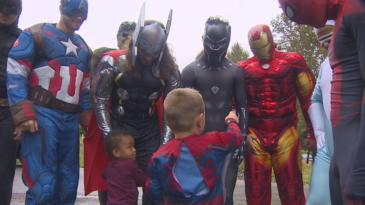 High school football players surprise birthday boy dressed as superheroes