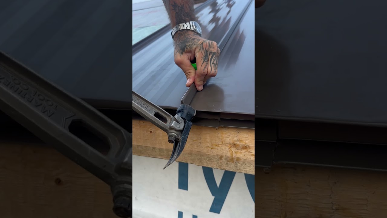 Showing a standing seam roof panel being installed #construction  #carpentry #metalroofing