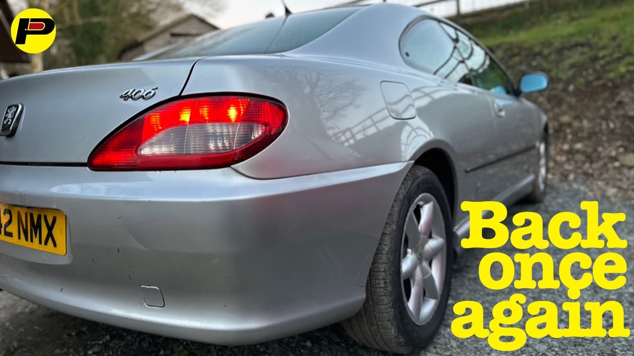 A man sits in a stricken Peugeot 406 Coupé and rambles on for about 11 minutes