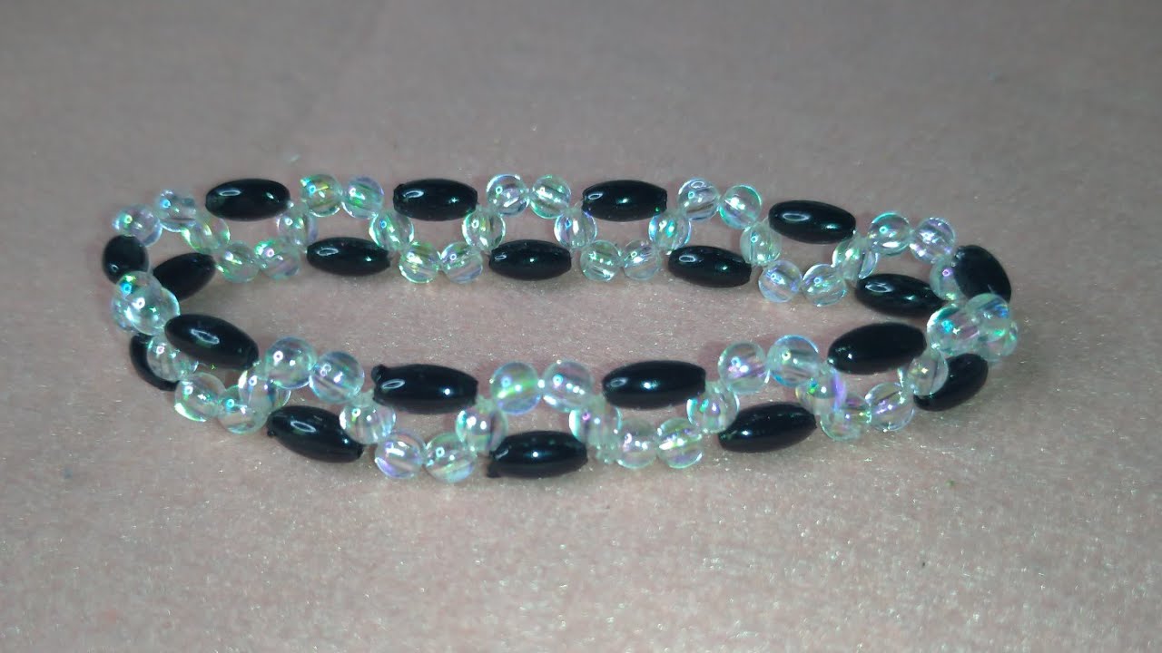 Pulseira entrelaçada de ondinha com arrozinho preto