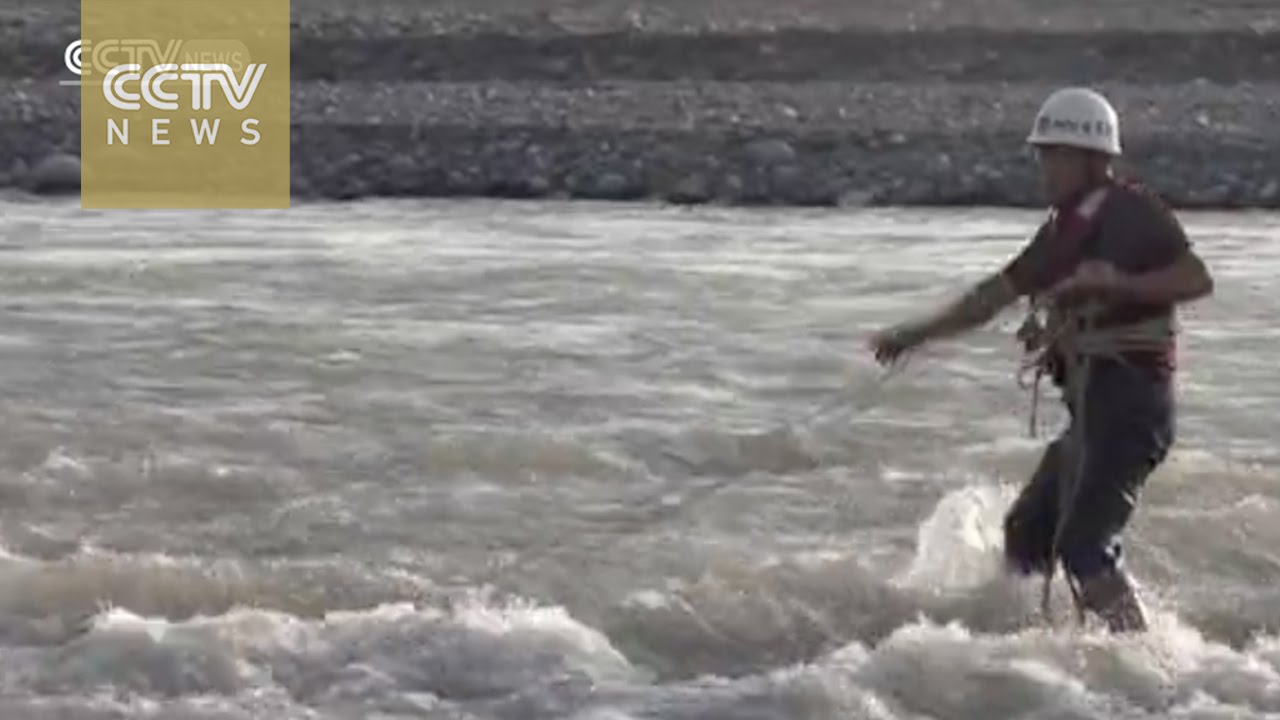 Dramatic footage shows two trapped jade-collectors rescued from rising tides