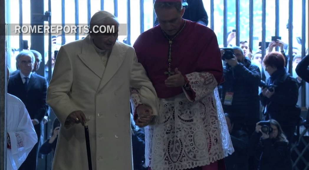 Pope Emeritus Benedict XVI walks through the Holy Door
