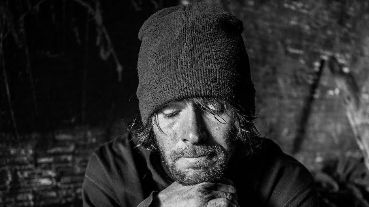 A Homeless man living in near complete darkness