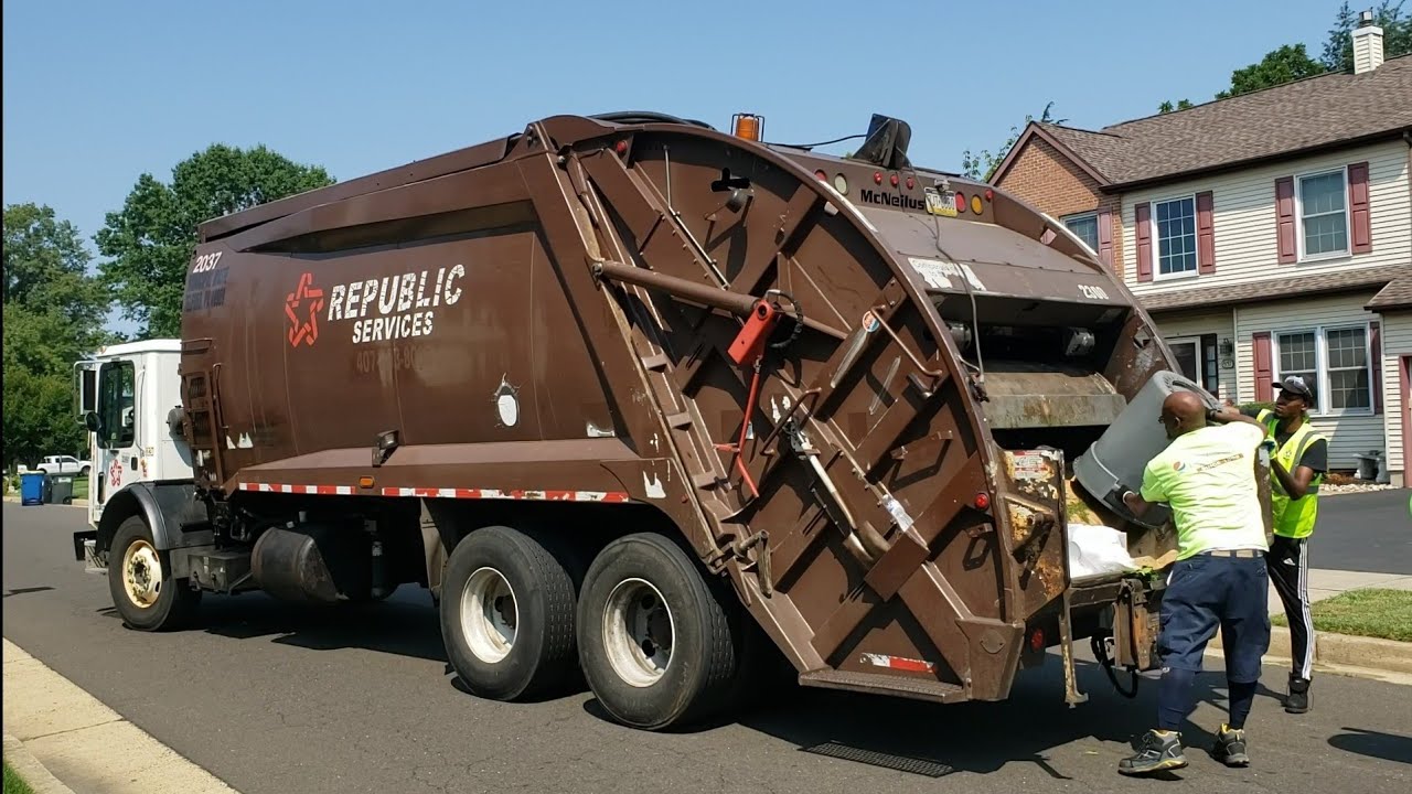 Republic's brown Mack MRU McNeilus rear loader garbage truck packing heavy trash and bulk