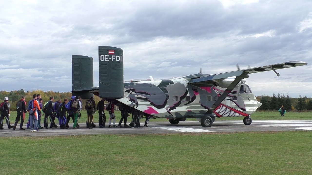 Pink Skyvan Short SC-7 Skyvan landing and takeoff at Airfield Punitz + skydiver