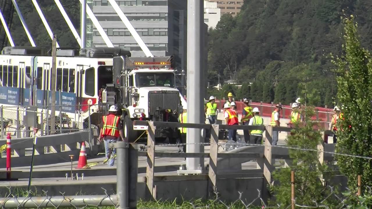 TriMet tests clearances for Orange line MAX track; train crosses Tilikum Crossing