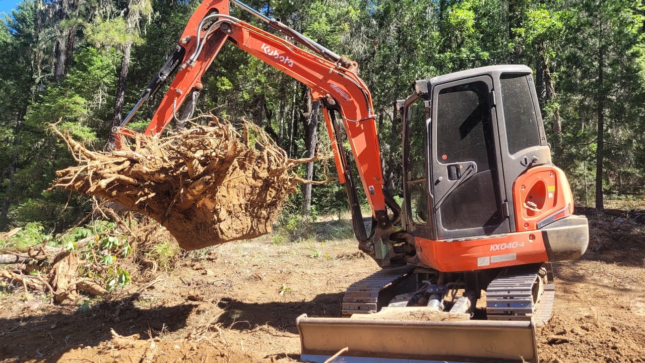 Clearing trees and stumps for a pad with the Kubota KX-040