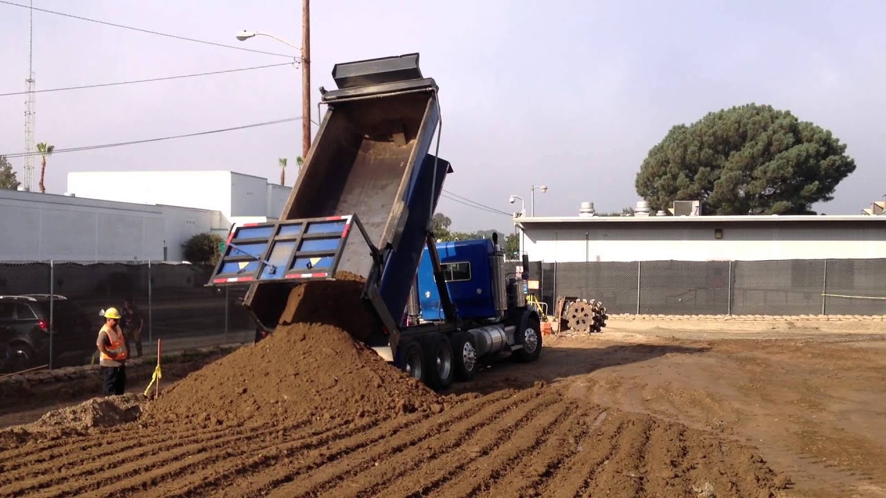 End dump truck unloading dirt