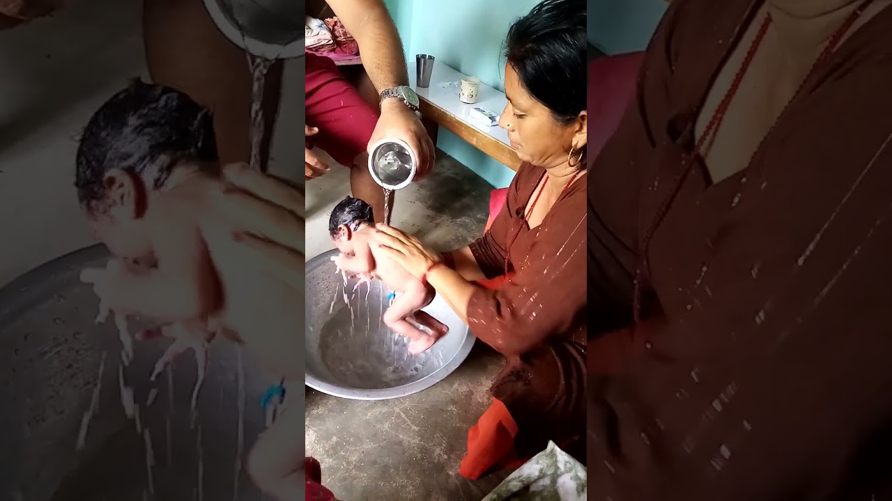 first time baby bath by grandmother.