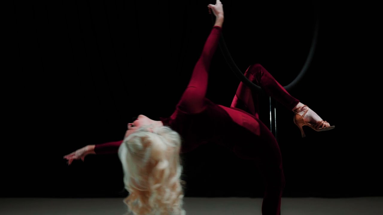 Kendra Daniels stunts on self standing lyra while singing At Last