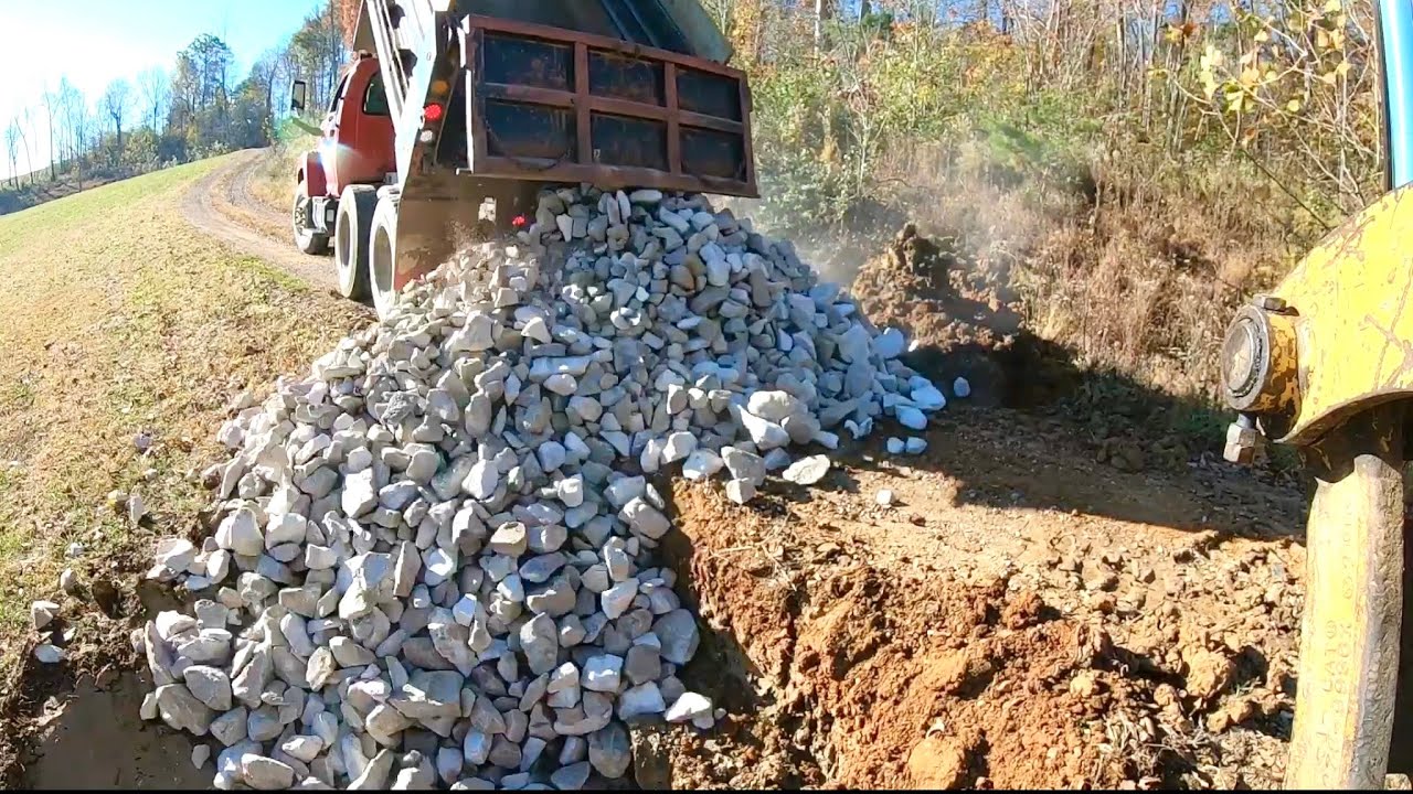 Installing Rip Rap on Re-Sloped Drainage Ditch - Full Repair Complete