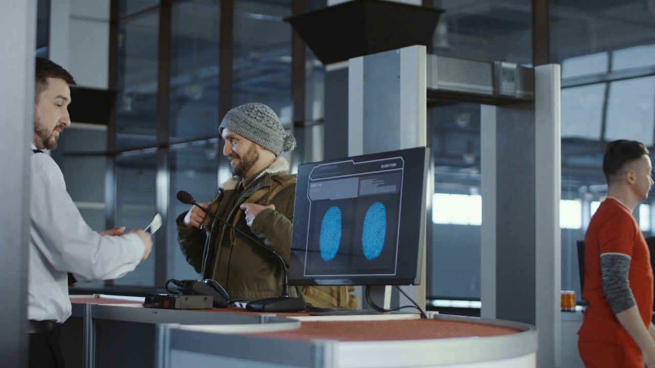Man Passing Biometric Scan at Airport Counter