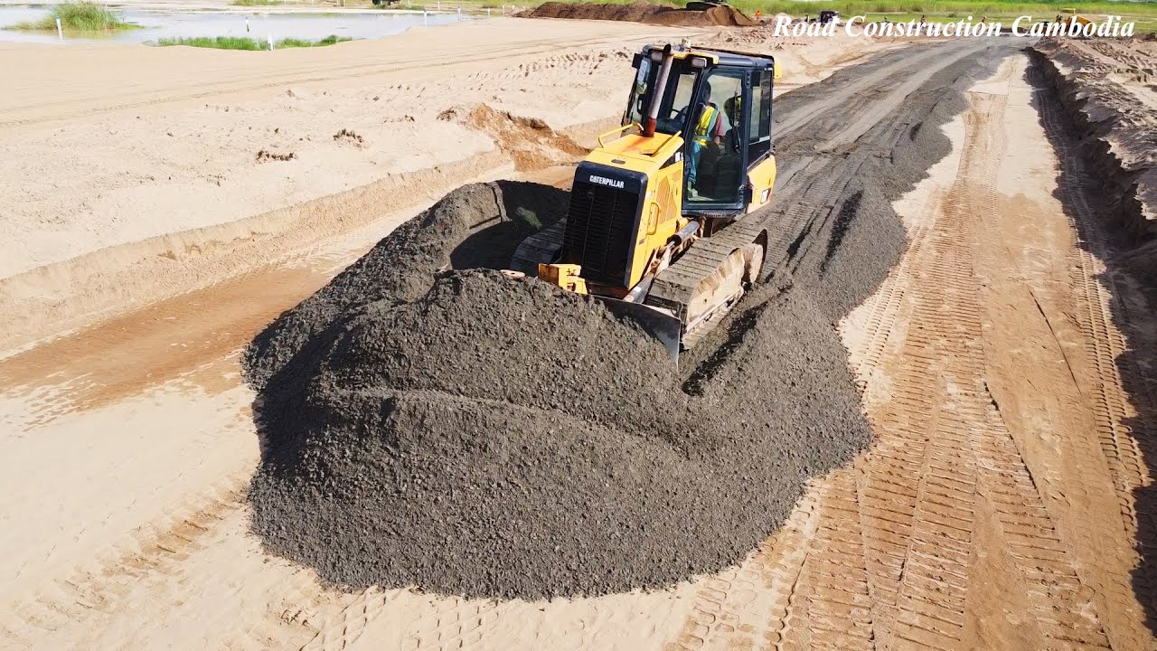 Skill Operator Bulldozer CAT D3K Spreading Gravel Build Road And 12 Wheel Dump Truck Dumping Gravel