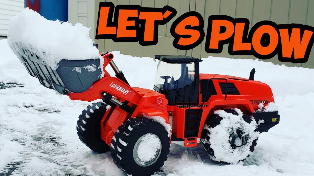 rc wheel loader plowing snow