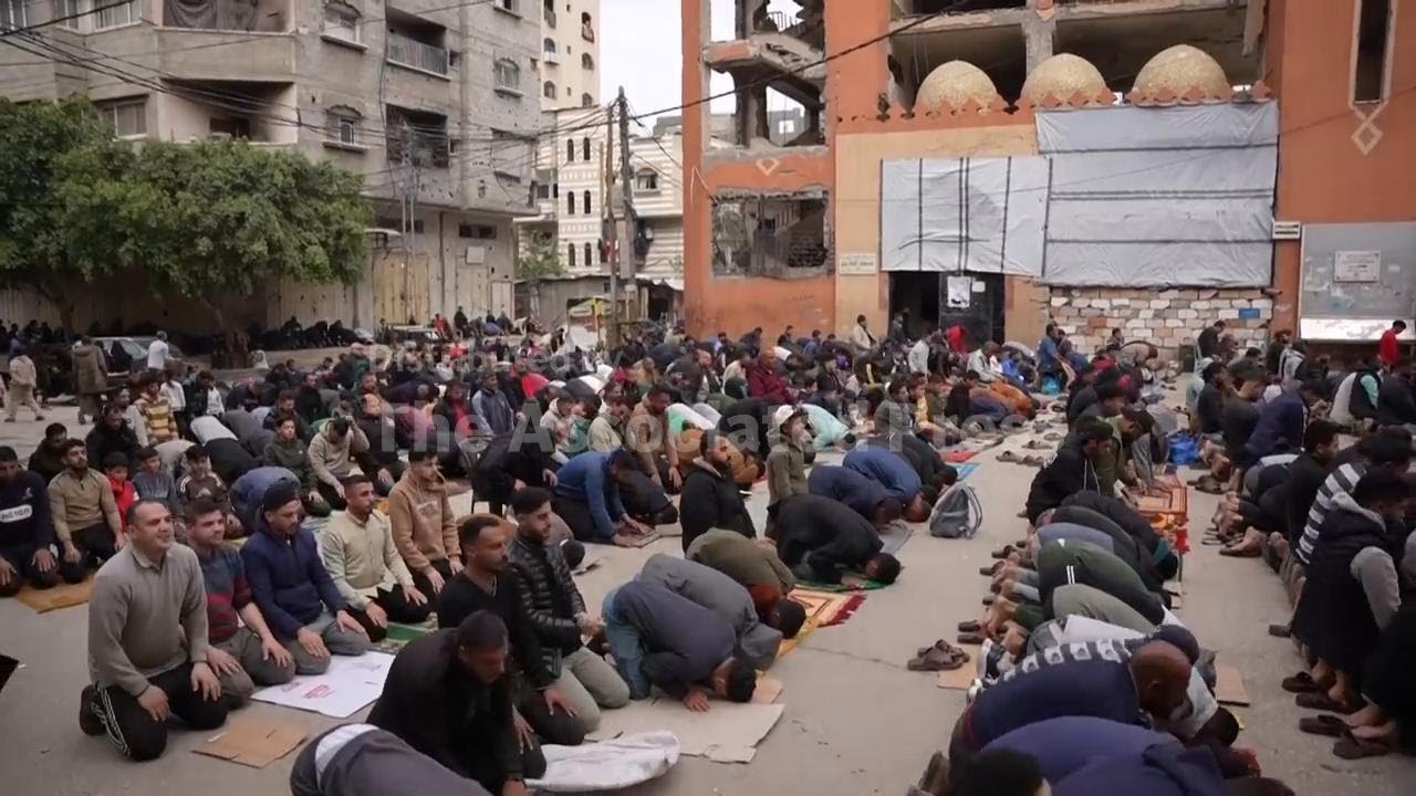 Palestinians attend Friday prayers outside destroyed mosque in Nuseirat