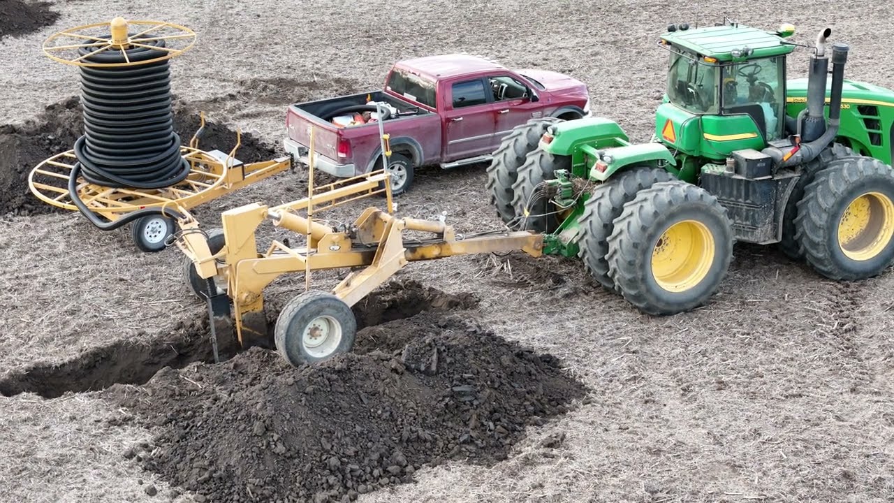 Installing drainage field tile with a plow. 2023