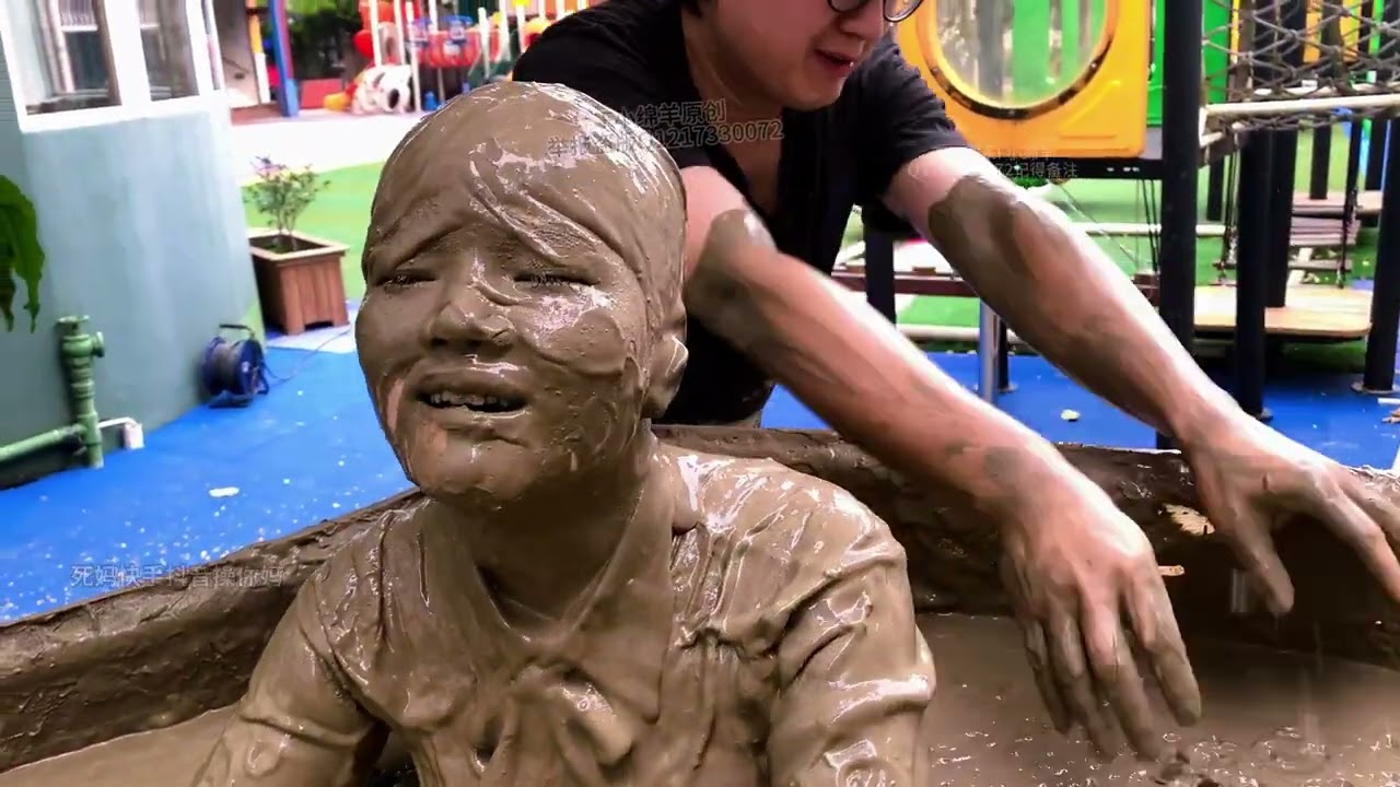 Two beautiful girls are playing in the mud pit, gradually sinking into it
