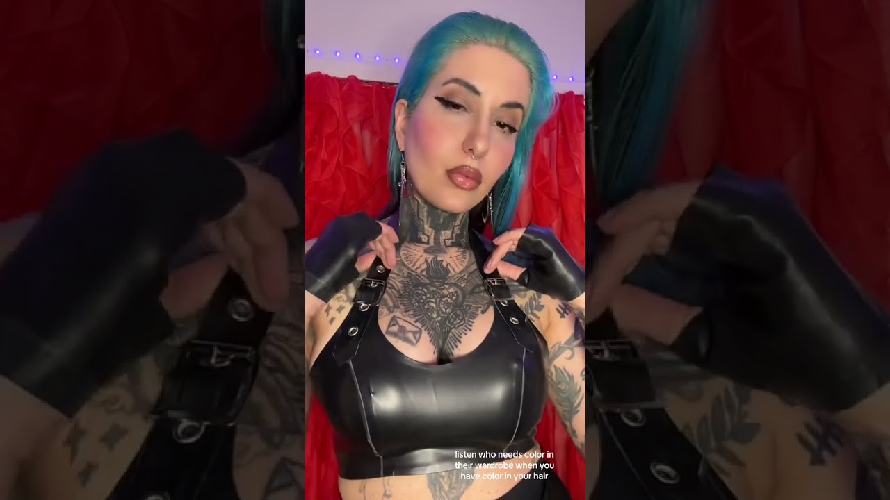 Blue hair, black gloves and buckled latex top