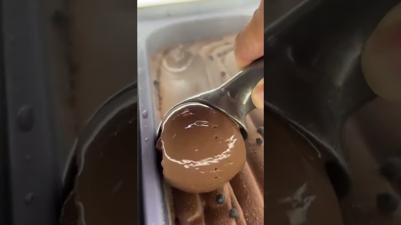 the process of taking the chocolate topping that will be mixed using a special spoon