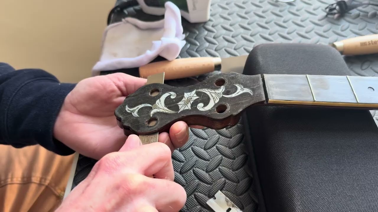 Peghead veneer removal on a 1910 Cole Eclipse banjo