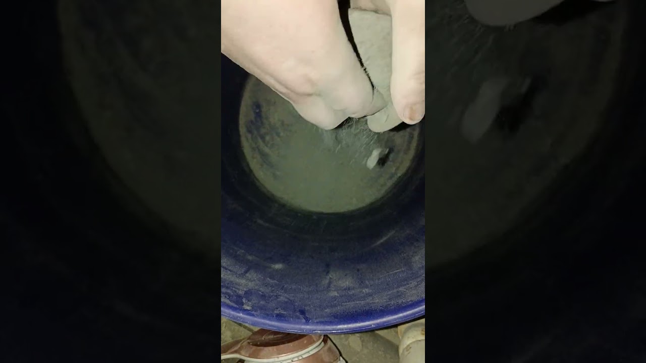 Recycled pure cement crumbling in a bucket
