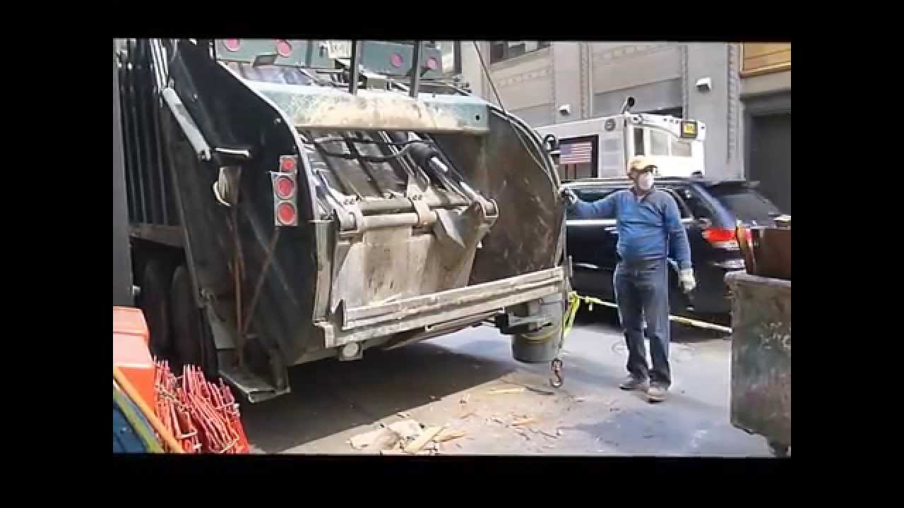 New York City garbage trucks - Day and night time curbside trash and waste pick-ups in mid Manhattan