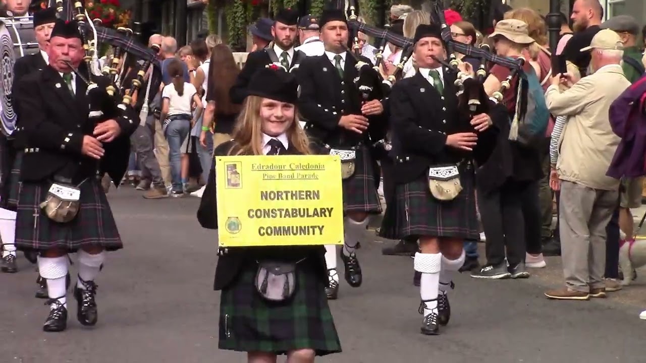 pipe bands marching down main street pitlochry games 23