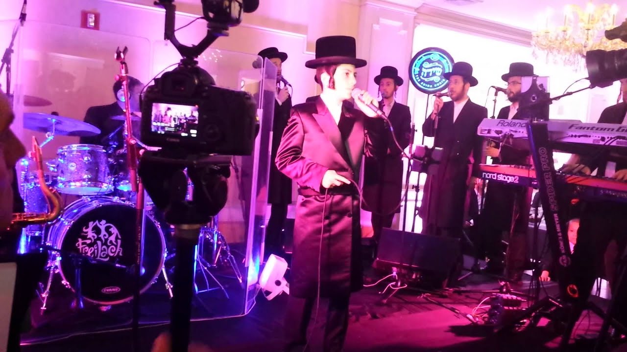 Bar Mitzvah boy Yitzy Rosinger takes the podium W/ Shirah Choir & Freilach Band