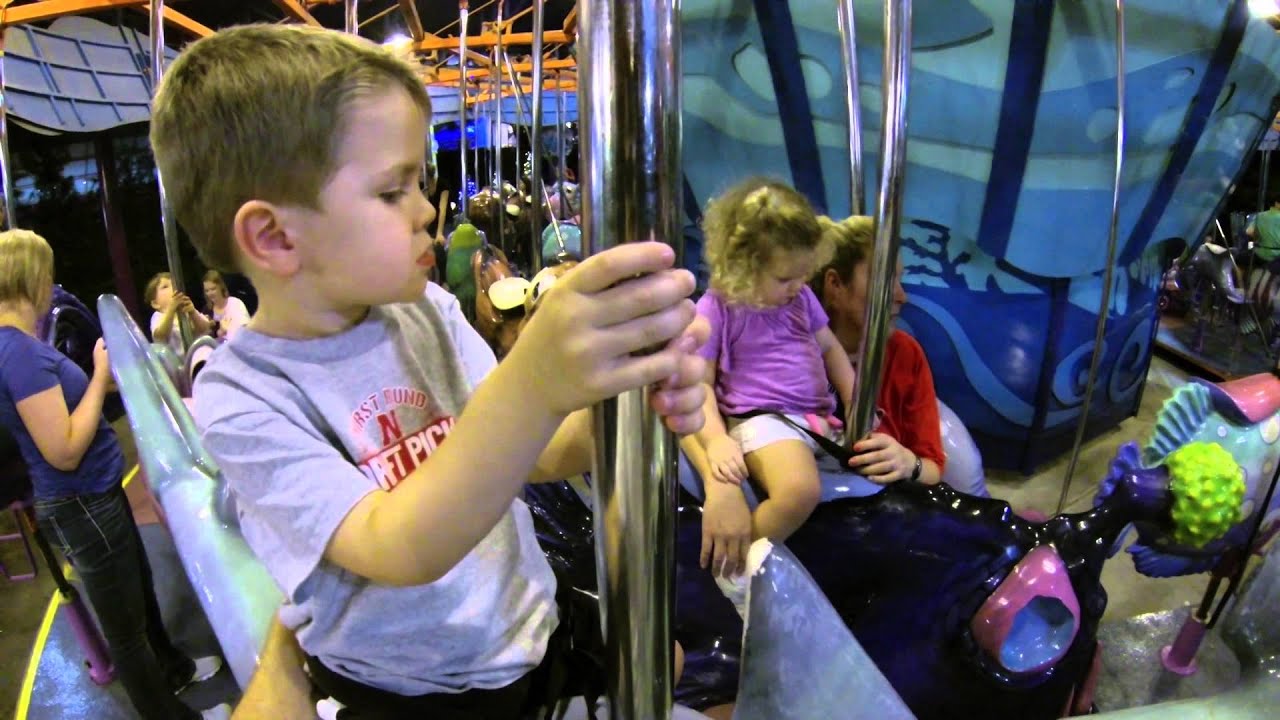 Kids riding a carousel at SeaWorld