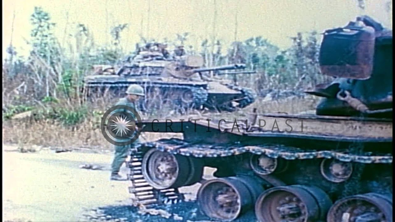US 1st Infantry Division soldiers check a destroyed M-48 Patton tank on a road in...HD Stock Footage