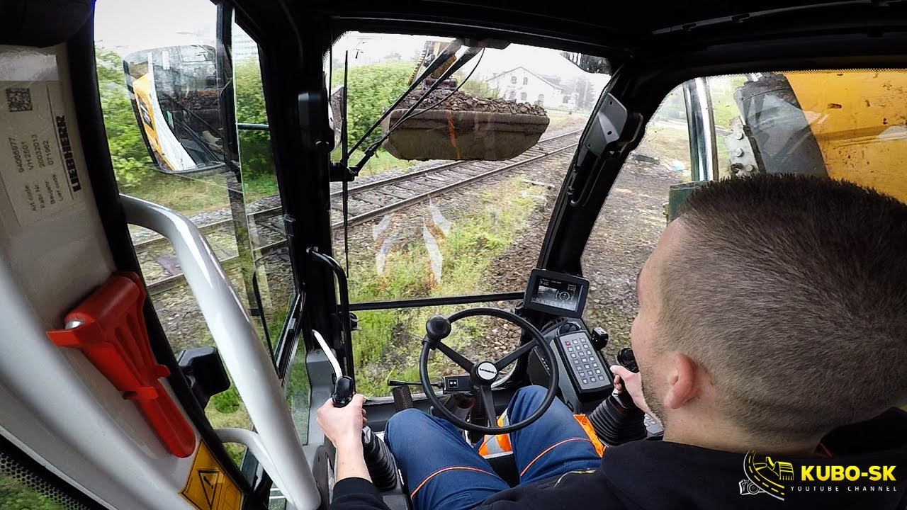 Liebherr A918 excavator digging macadam from railway track - cab view