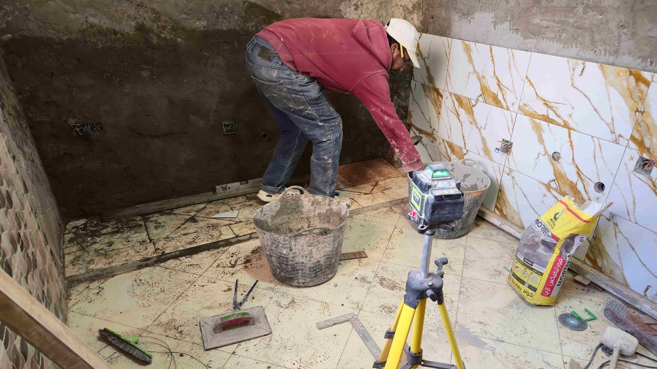 Installation of ceramic wall tiles in a modern kitchen using porcelain
