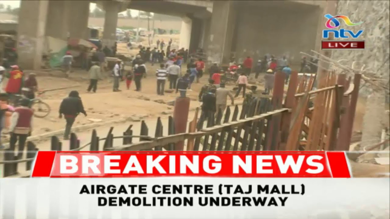 Police use tear gas to disperse on lookers at the ongoing Taj Mall demolition