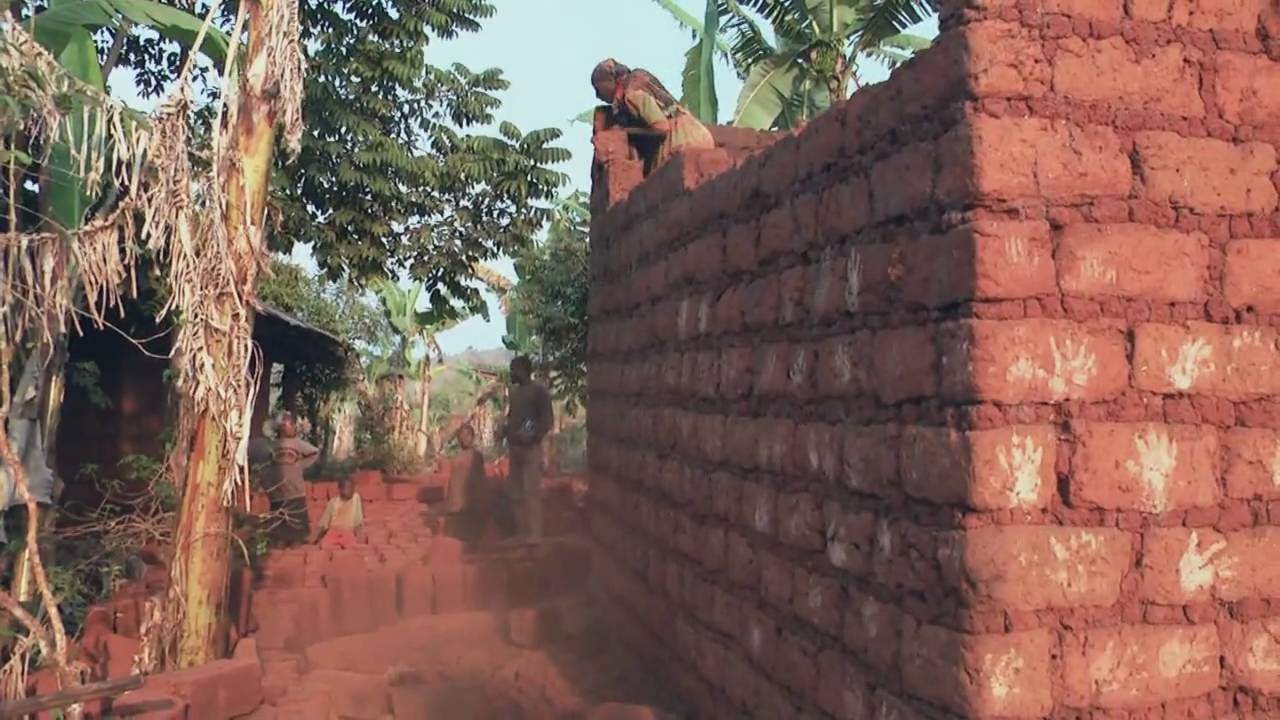 Woman building african house with her own hands!